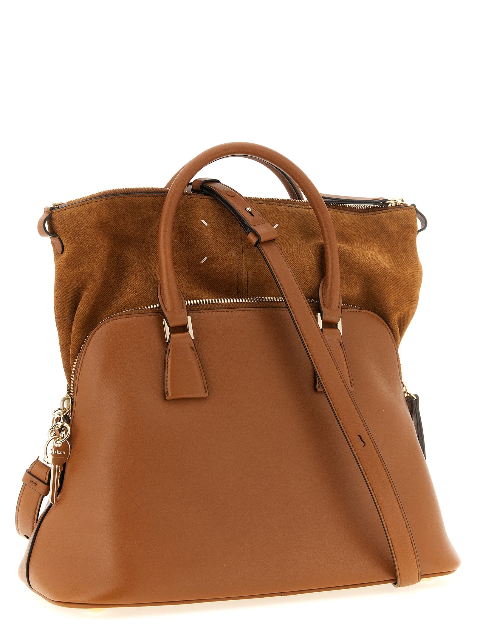 Discover the Maison Margiela ‘5AC Soft’ shoulder bag, a luxurious blend of calfskin and suede, embodying sophisticated deconstruction and timeless elegance.