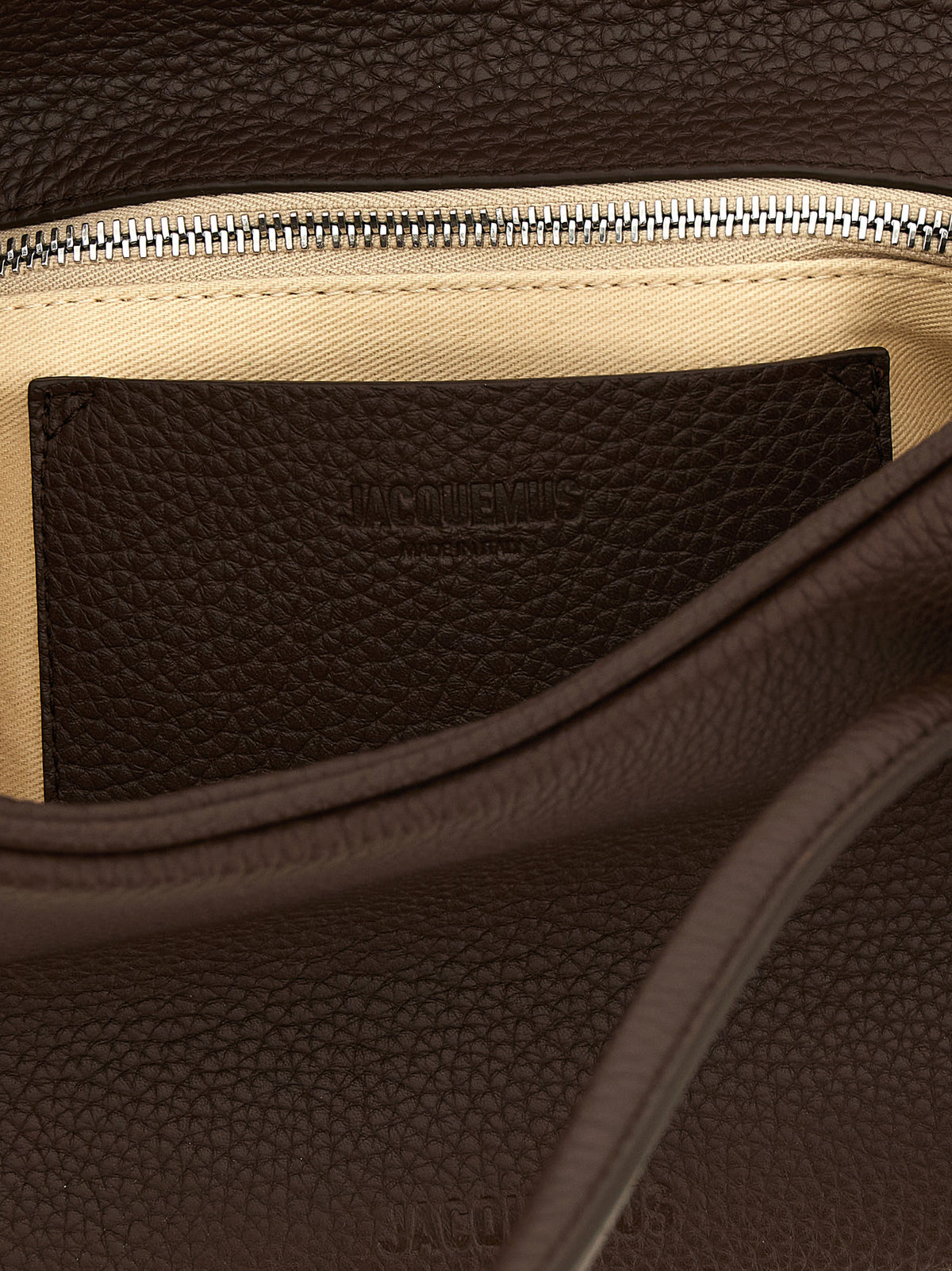 Indulge in the exquisite Jacquemus Brown Calfskin Shoulder Bag, a timeless masterpiece of hammered leather that elevates your style with bold sophistication and refined elegance.
