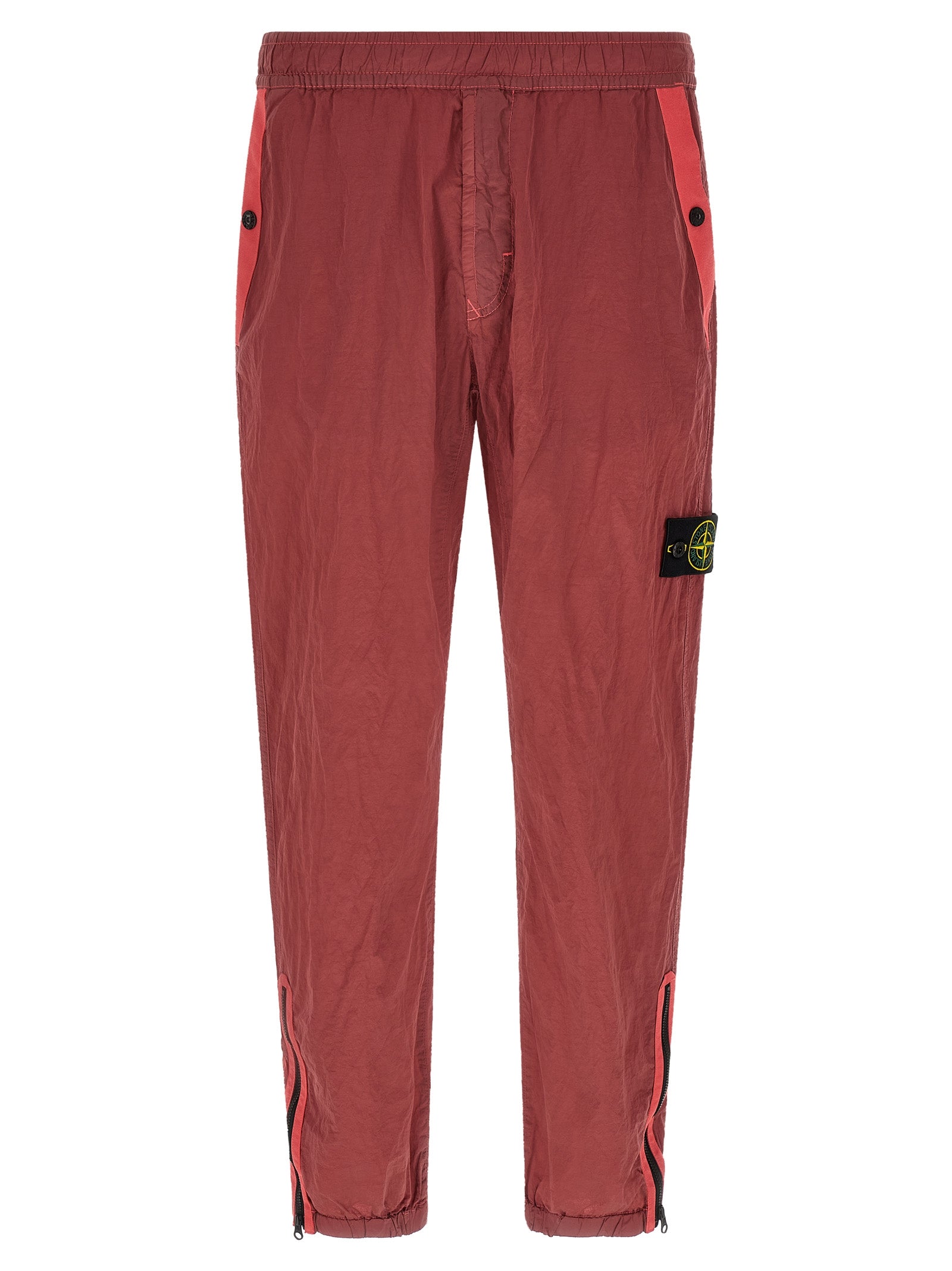 Elevate your urban wardrobe with Stone Island's Red Polyamide Joggers, crafted from innovative Nylon Metal Econyl® for a sophisticated, structured finish that embodies luxury.