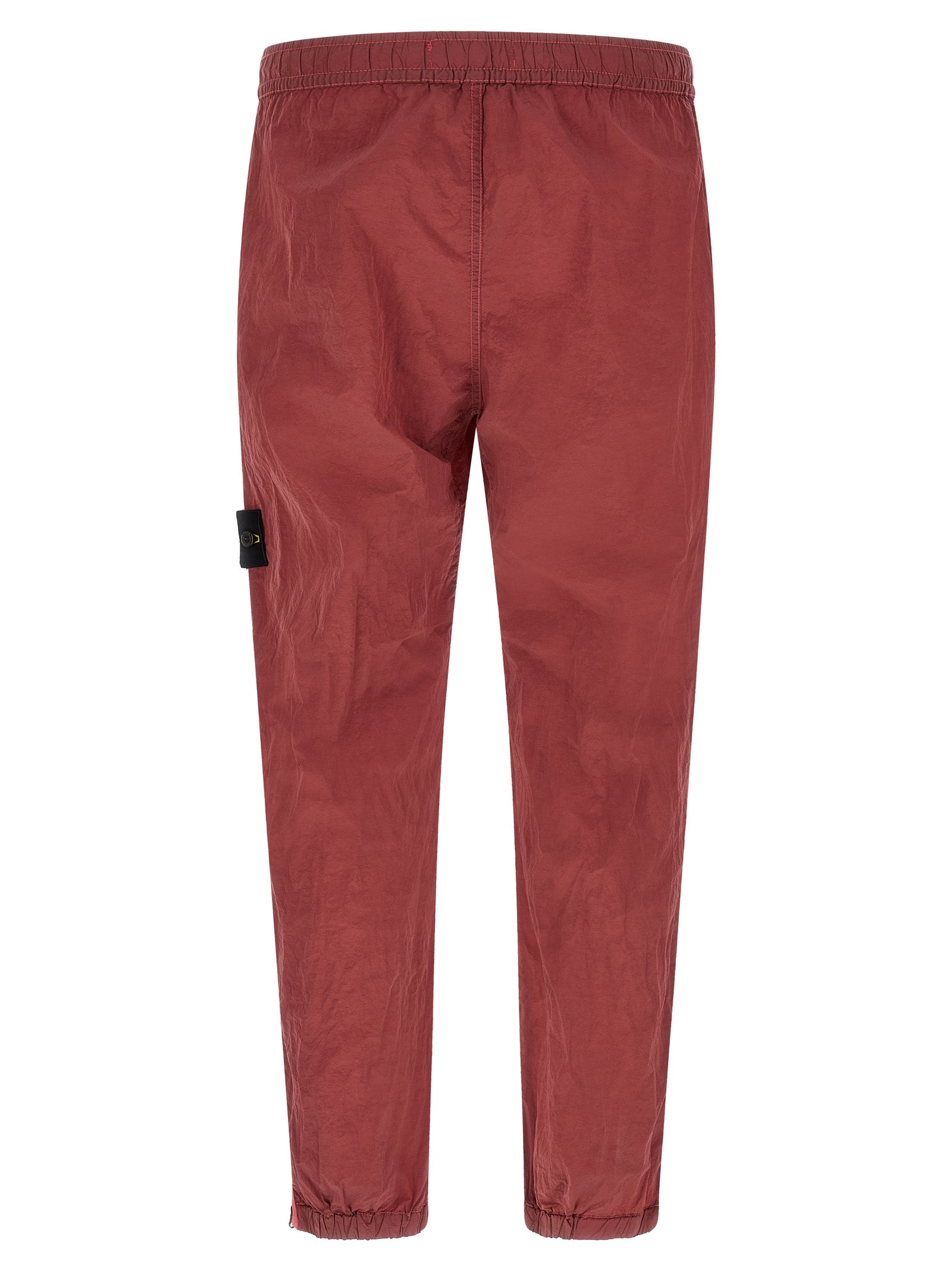 Elevate your urban wardrobe with Stone Island's Red Polyamide Joggers, crafted from innovative Nylon Metal Econyl® for a sophisticated, structured finish.
