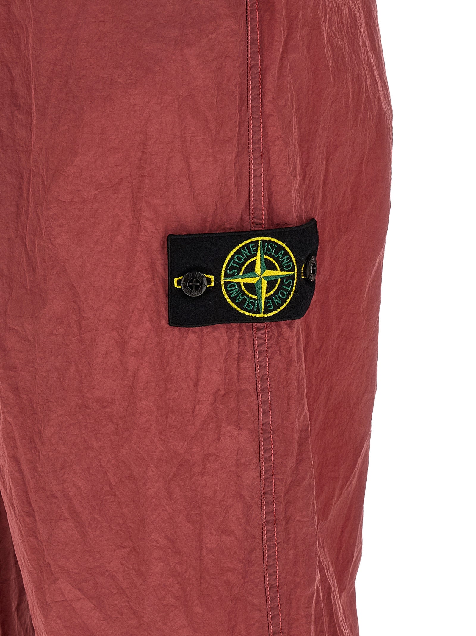 Elevate your urban wardrobe with Stone Island's Red Polyamide Joggers, crafted from innovative Nylon Metal Econyl® for a sophisticated, structured finish.