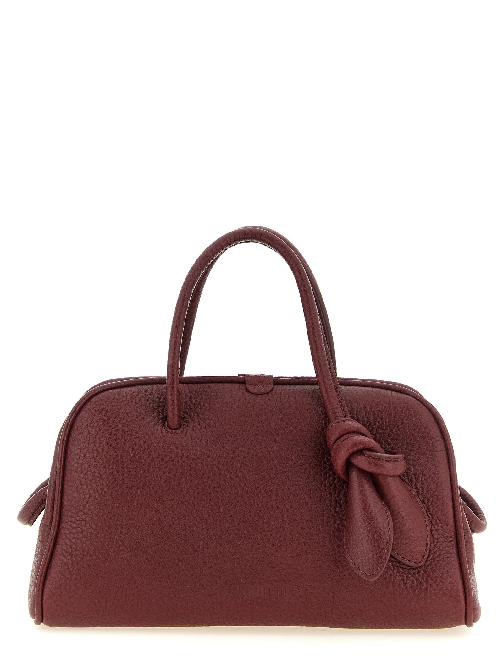 Discover the Jacquemus Le Petit Turismo handbag, a sculptural masterpiece in rich Bordeaux calfskin, redefining elegance for the discerning fashion connoisseur.