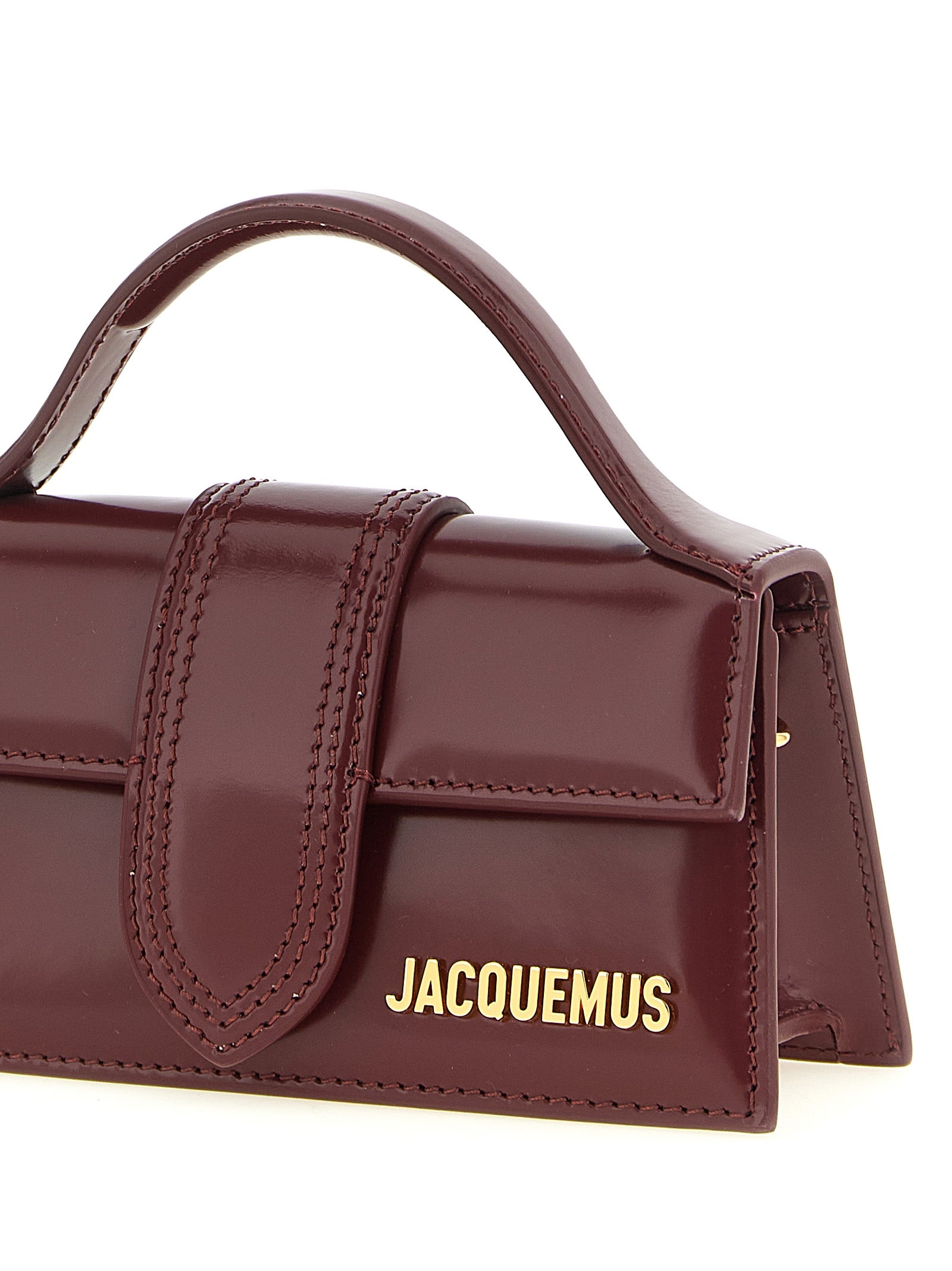 Indulge in the exquisite Jacquemus Bordeaux Calfskin Handbag, a geometric masterpiece of luxurious calfskin leather, perfect for the avant-garde fashionista seeking timeless elegance.