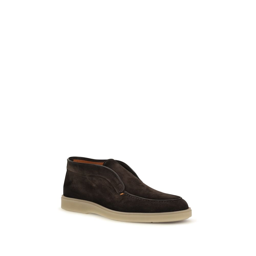 Indulge in the exquisite craftsmanship of Santoni's Brown Suede Leather Slip-On Loafers, where luxurious suede meets timeless elegance for the discerning individual.