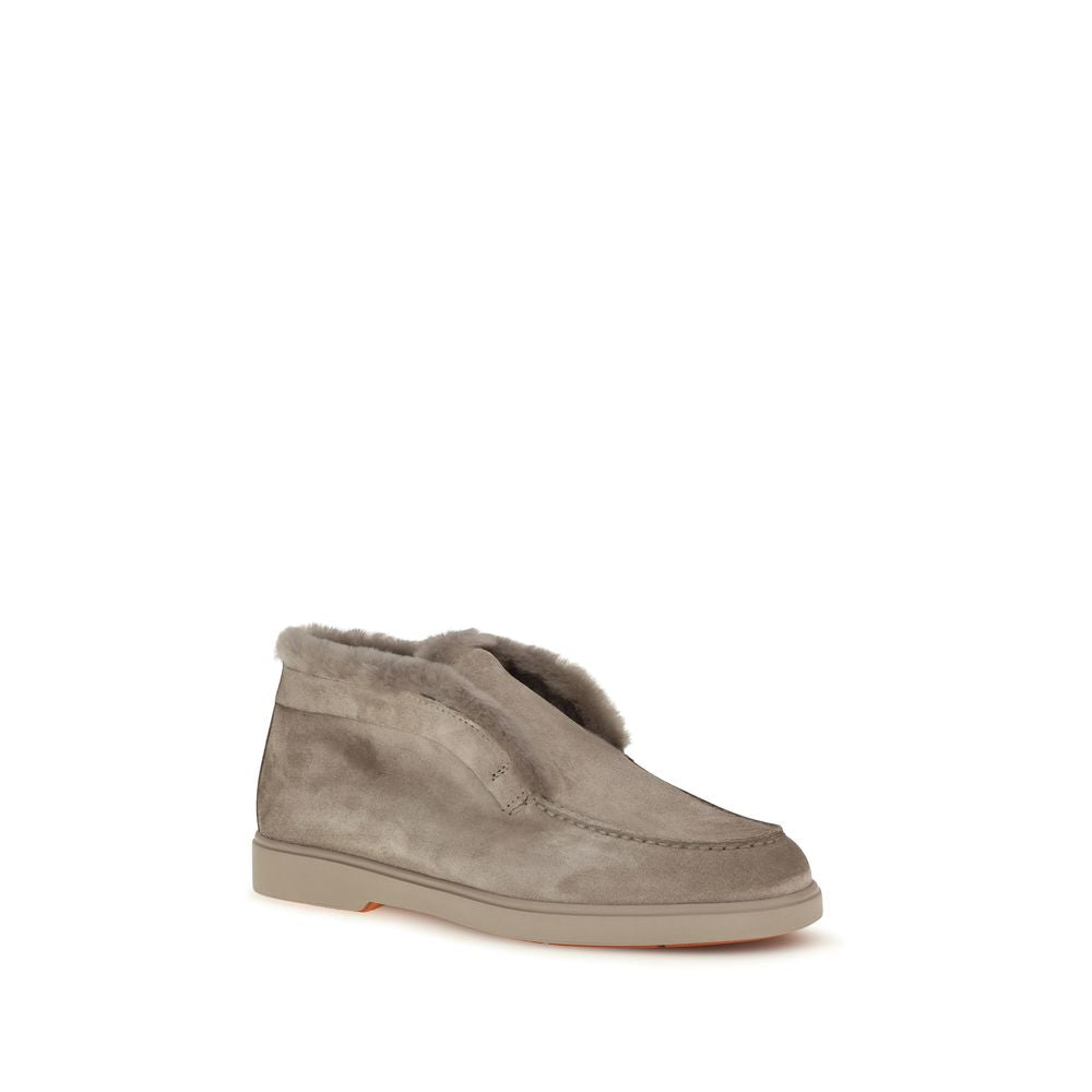 Indulge in the exquisite allure of Santoni's Beige Faux Fur Ankle Boots, where soft calf suede meets cruelty-free luxury, embodying timeless elegance for the discerning individual.
