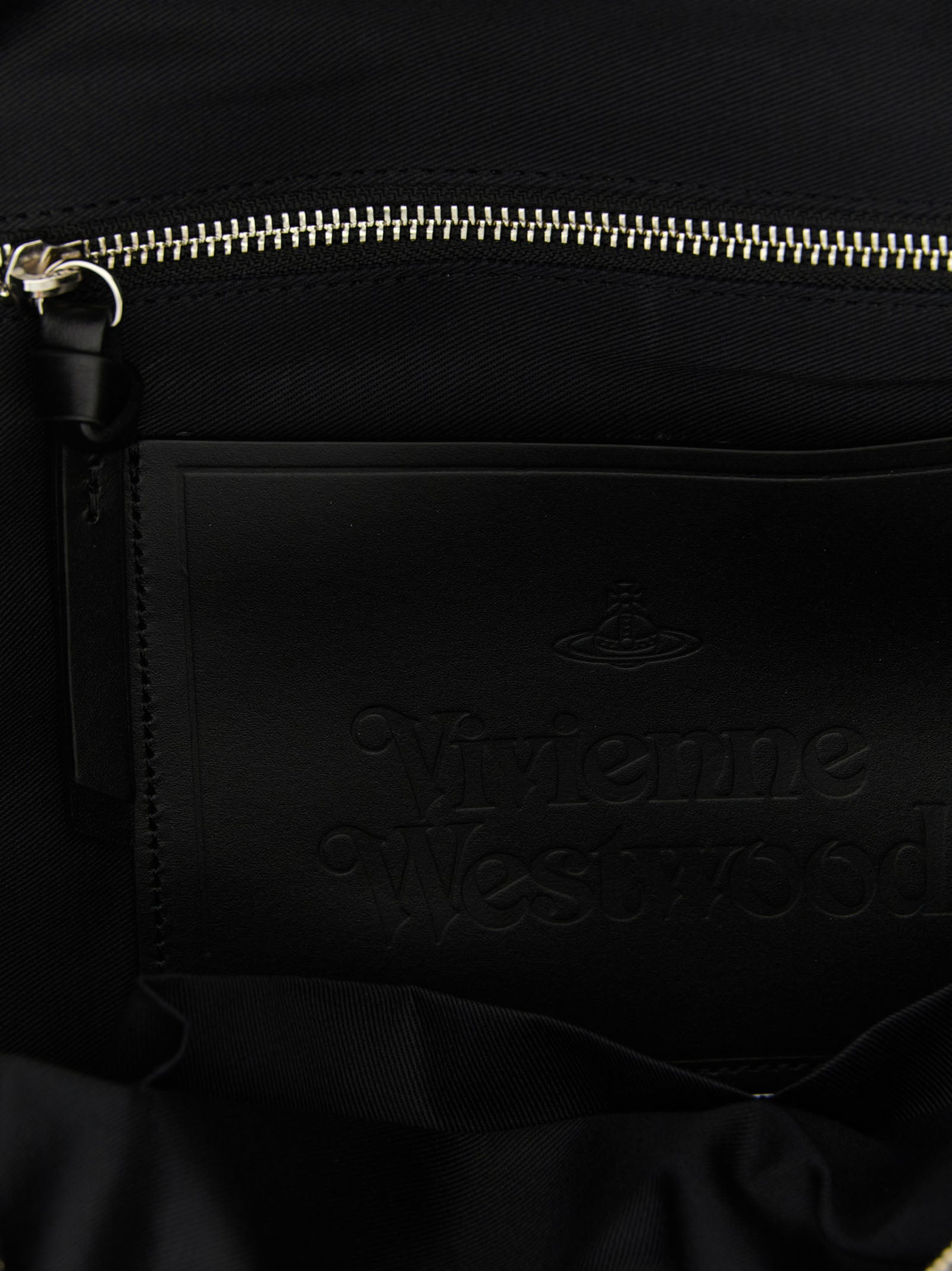 Discover the Vivienne Westwood Black Cotton Backpack, a fusion of avant-garde design and practical elegance, crafted for those who embrace luxury and individuality.