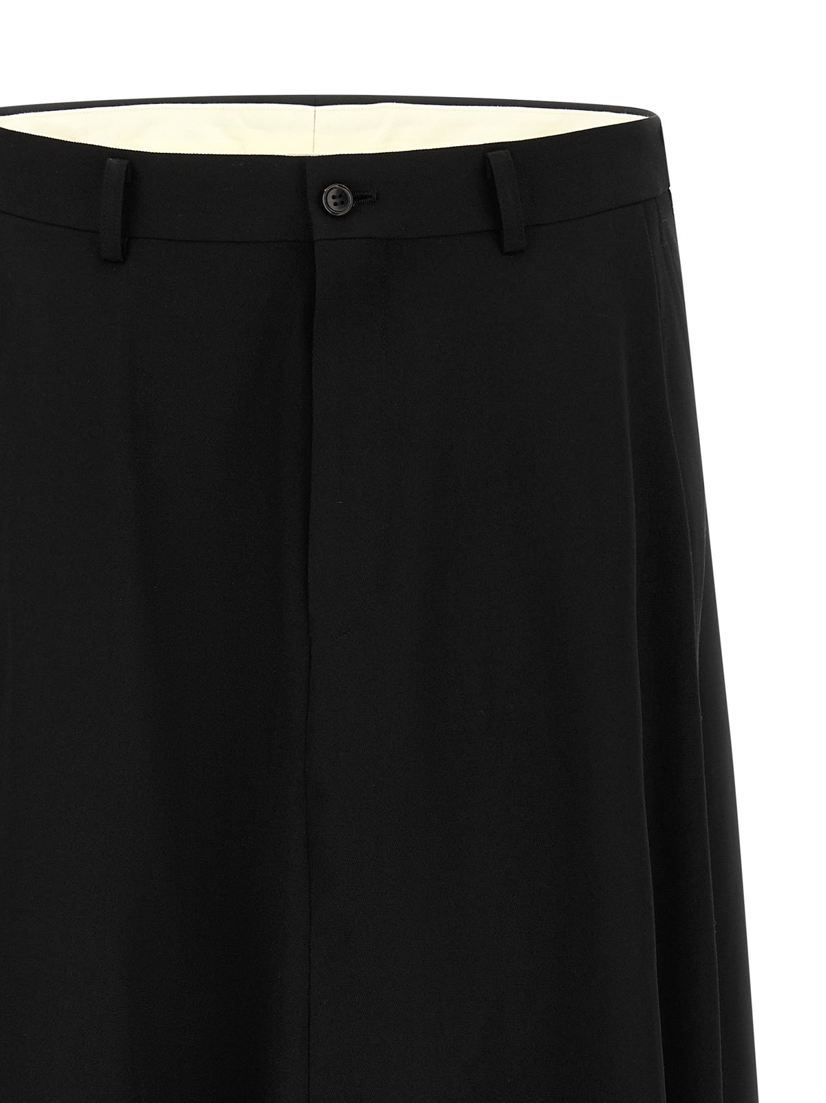 Discover the avant-garde allure of Comme des Garçons Homme Plus black wool dress pants, where bold tailoring meets luxurious craftsmanship for a statement of sophistication.