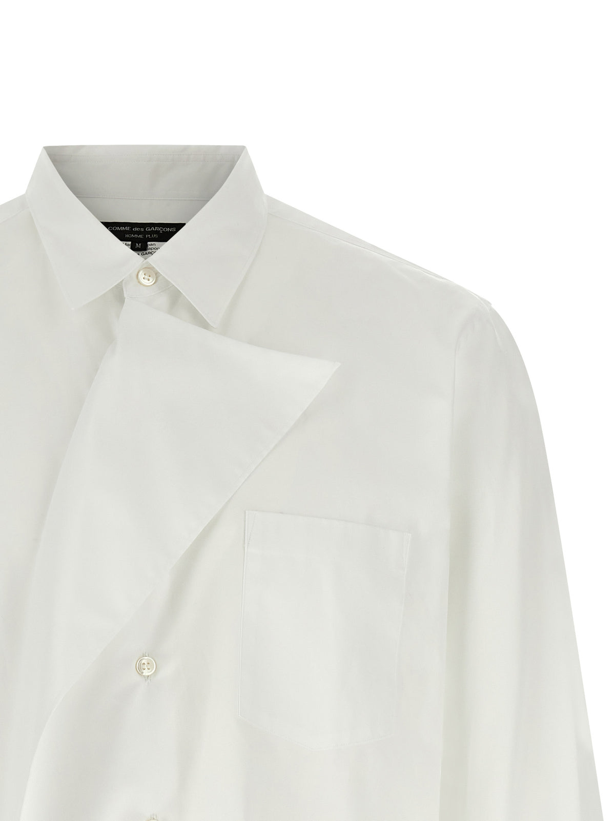 Elevate your wardrobe with the Comme Des Garçons White Cotton Blouse, a masterpiece of avant-garde design and classic tailoring, celebrating exquisite craftsmanship and timeless elegance.