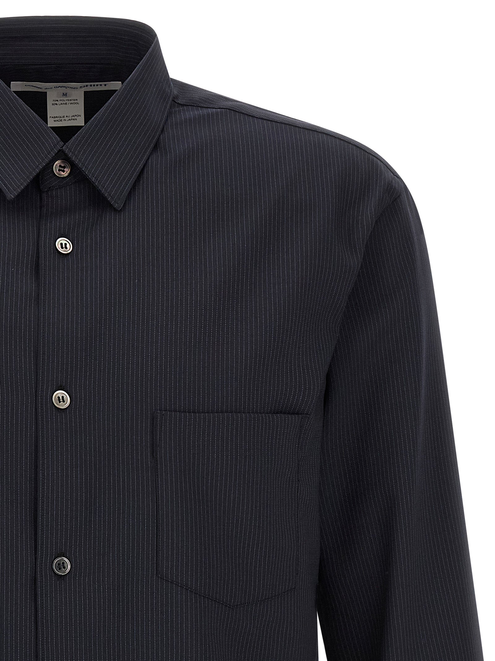 Discover the exquisite Comme Des Garçons Blue Polyester Blouse, a masterful blend of elegance and modernity, crafted for those who appreciate refined sophistication.