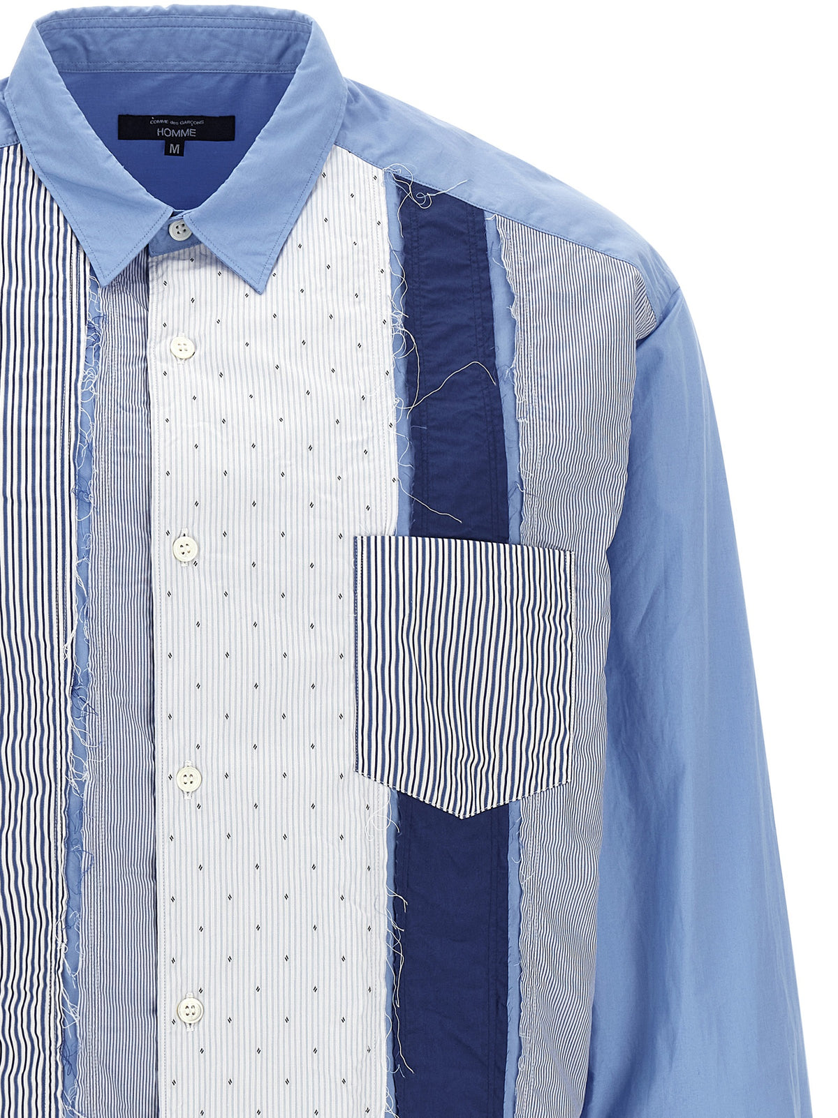 Elevate your wardrobe with the Comme Des Garçons Blue Cotton Blouse, a masterpiece of deconstructed design and luxurious craftsmanship, perfect for the discerning fashion connoisseur.