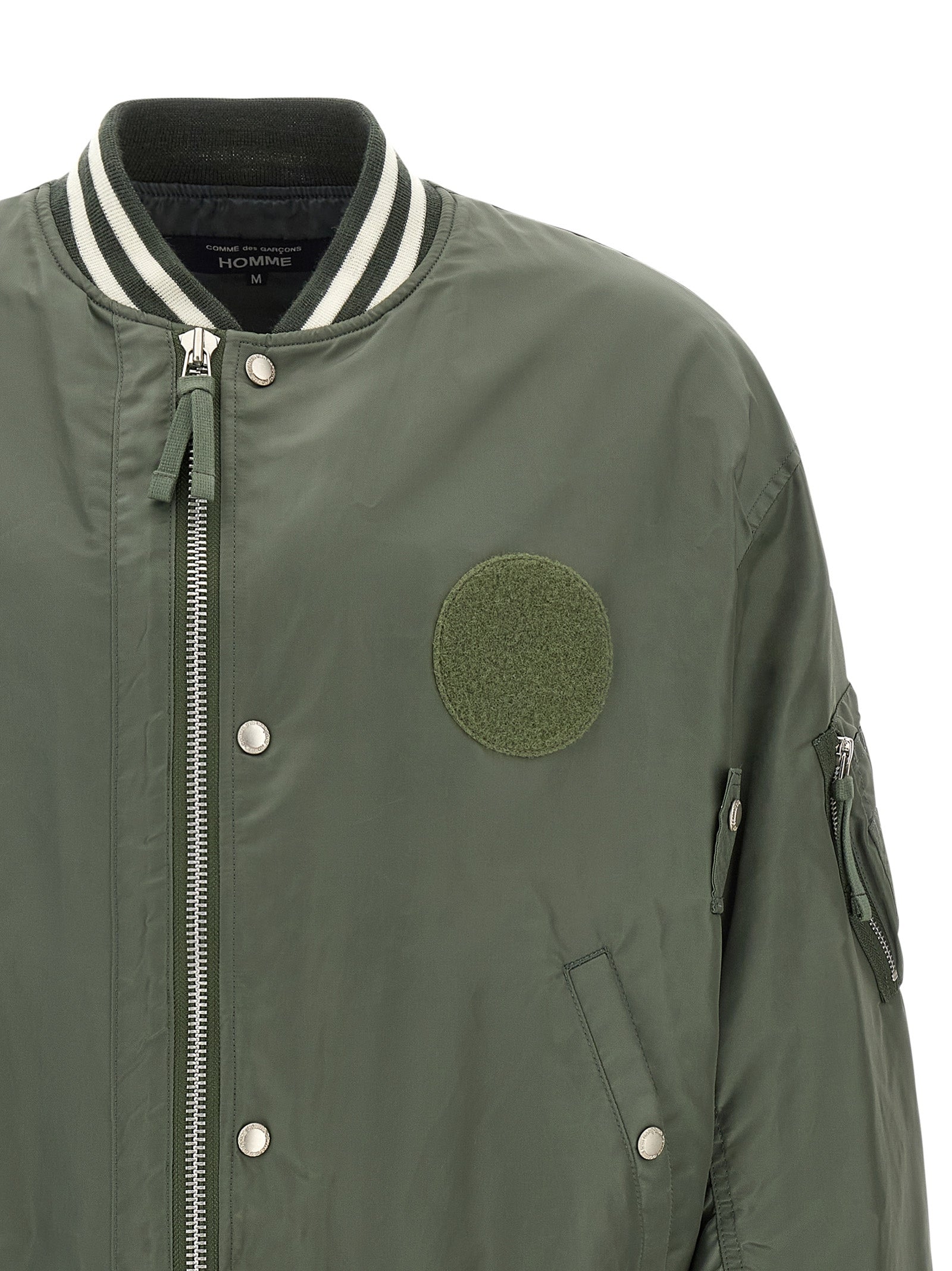 Elevate your style with the Comme Des Garçons Bicolor Nylon Bomber, a luxurious blend of modern design and timeless sophistication, crafted for the discerning individual.