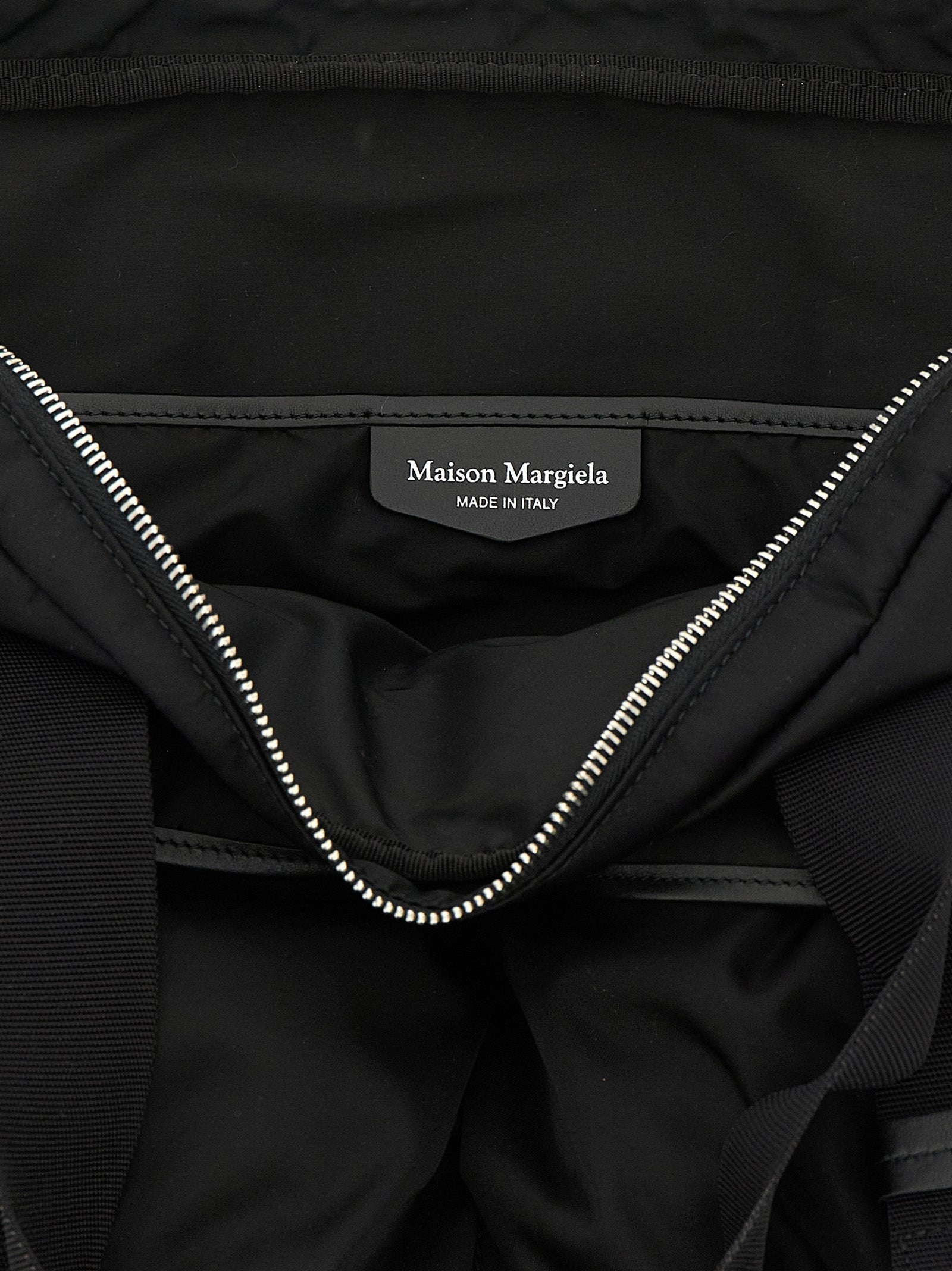 Discover the Maison Margiela Black Polyamide Tote Bag, a fusion of industrial elegance and timeless allure, crafted for those who command sophistication in every moment.
