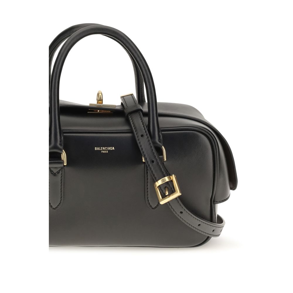 Indulge in the exquisite craftsmanship of the Balenciaga Black Lamb Leather Handbag, a timeless piece that elevates any ensemble with its luxurious silhouette and iconic design.