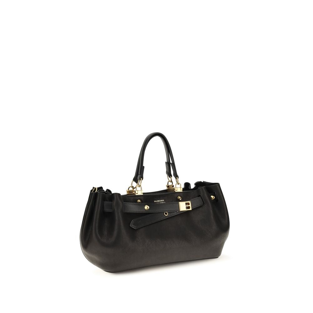 Indulge in the exquisite Balenciaga Black Calf Leather Bos Taurus Shoulder Bag, a testament to Italian craftsmanship, designed for those who embody elegance and authority.