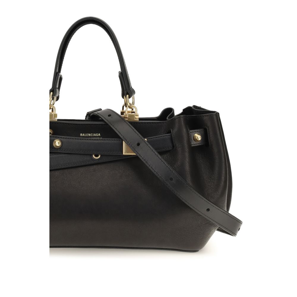 Indulge in the exquisite Balenciaga Black Calf Leather Bos Taurus Shoulder Bag, a testament to Italian craftsmanship, merging luxury with timeless elegance for the discerning individual.