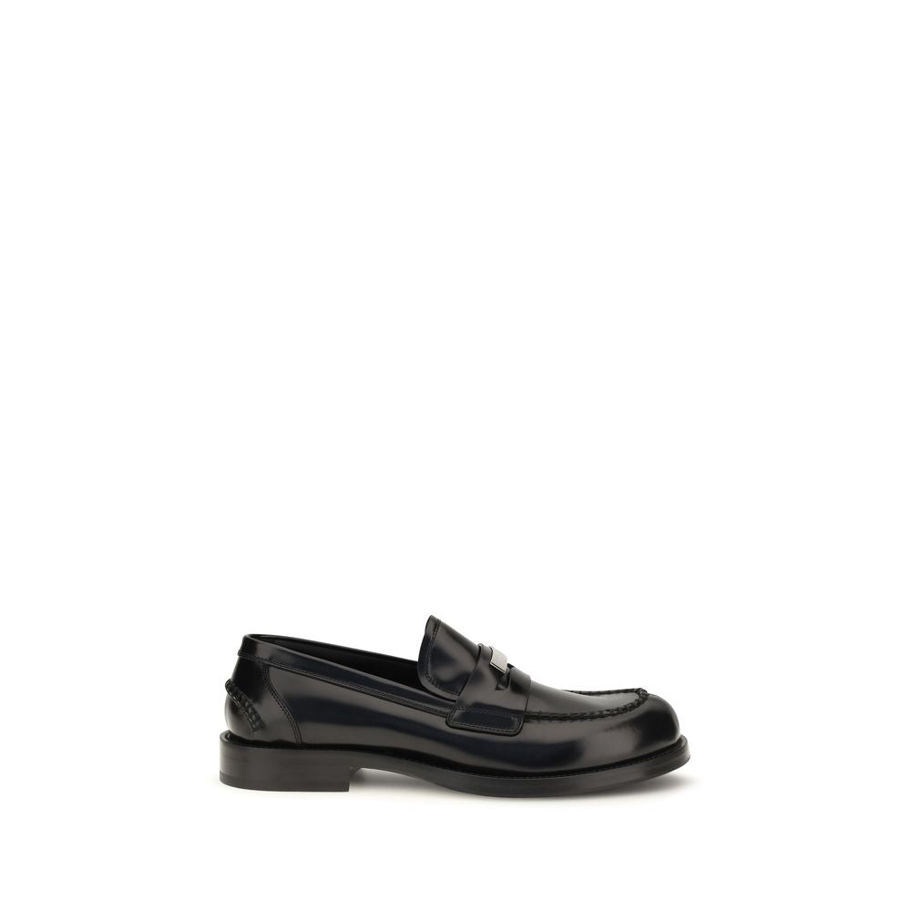 Experience the exquisite craftsmanship of Dolce & Gabbana's Black Calf Leather Bos Taurus Slip-On Loafers, a timeless symbol of luxury and elegance, made in Italy.