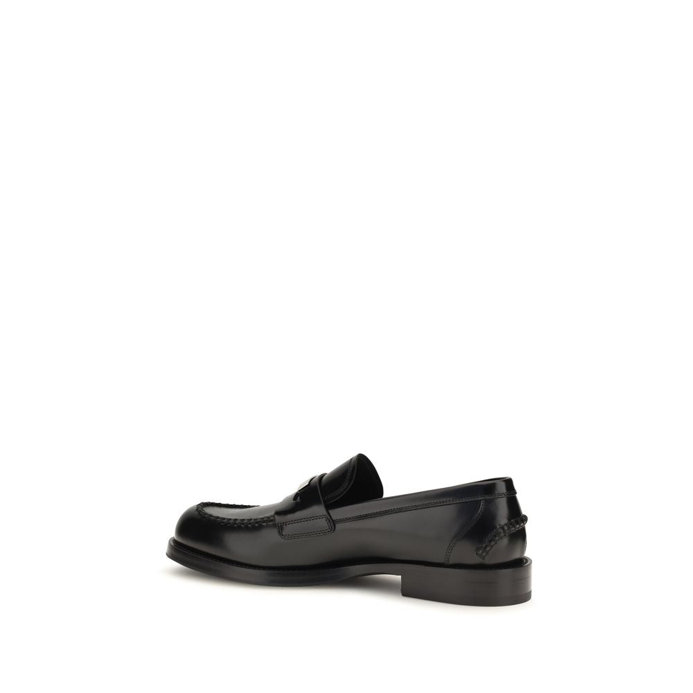 Indulge in the exquisite craftsmanship of Dolce & Gabbana's Black Calf Leather Bos Taurus Slip-On Loafers, where luxury meets artistry for the discerning individual.