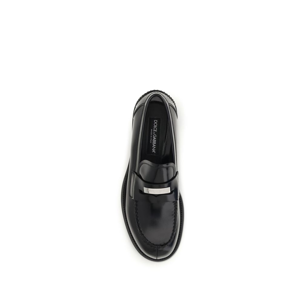 Indulge in the exquisite craftsmanship of Dolce & Gabbana's Black Calf Leather Bos Taurus Slip-On Loafers, where refined artisanal details elevate your style to new heights.