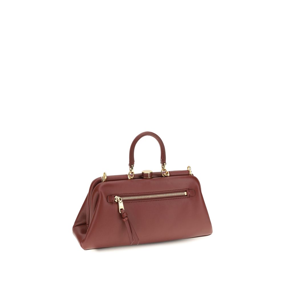 Indulge in the exquisite craftsmanship of the Dolce & Gabbana Red Lamb Ovis Aries Handbag, a timeless accessory that embodies luxury and sophistication for the discerning individual.