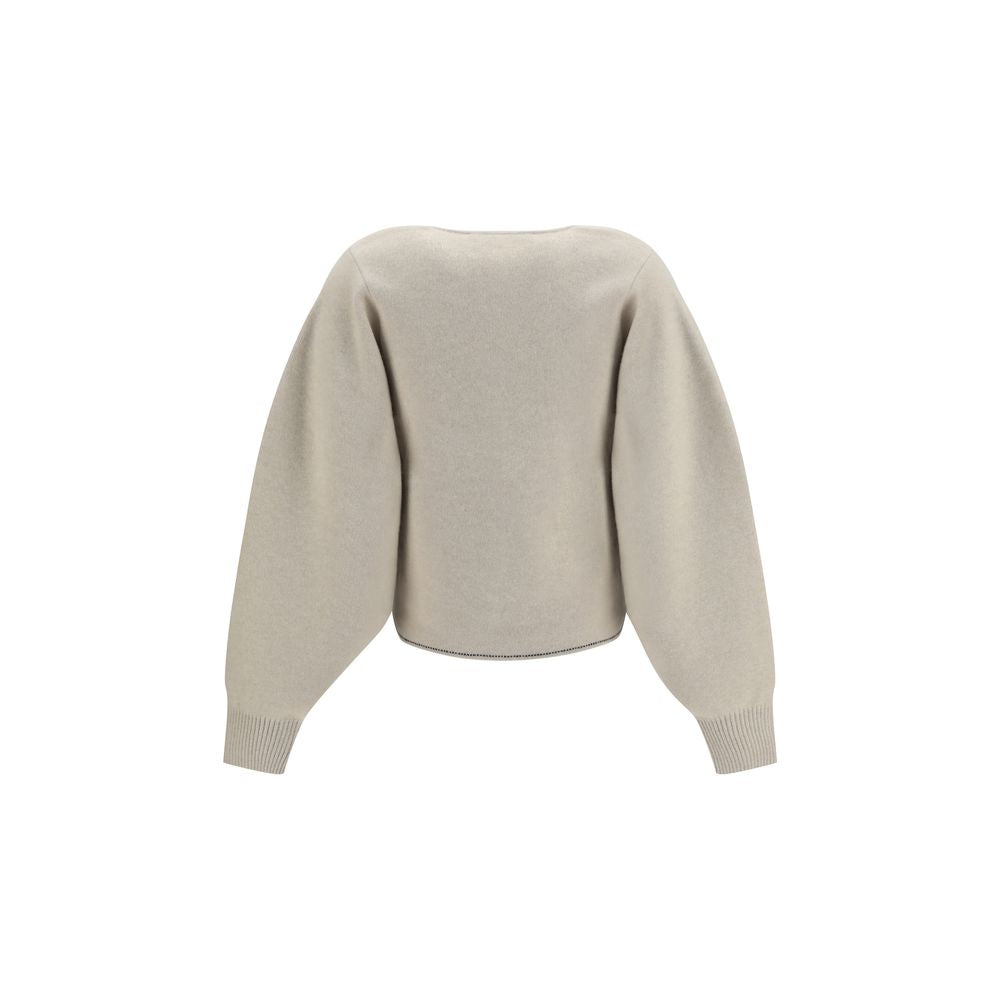 Indulge in the elegance of the Jacquemus Beige Wool Oves Aries Cardigan, a luxurious blend of wool and cashmere, designed for those who appreciate refined craftsmanship and timeless style.