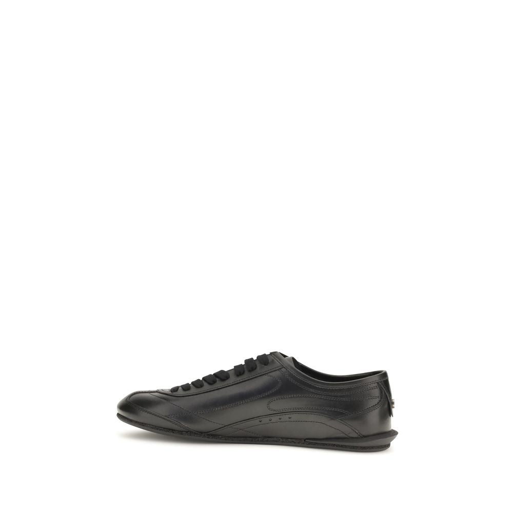 Indulge in the exquisite craftsmanship of Dolce & Gabbana's Black Calf Leather Bos Taurus Low Top Sneakers, where luxury meets refined elegance for the discerning individual.