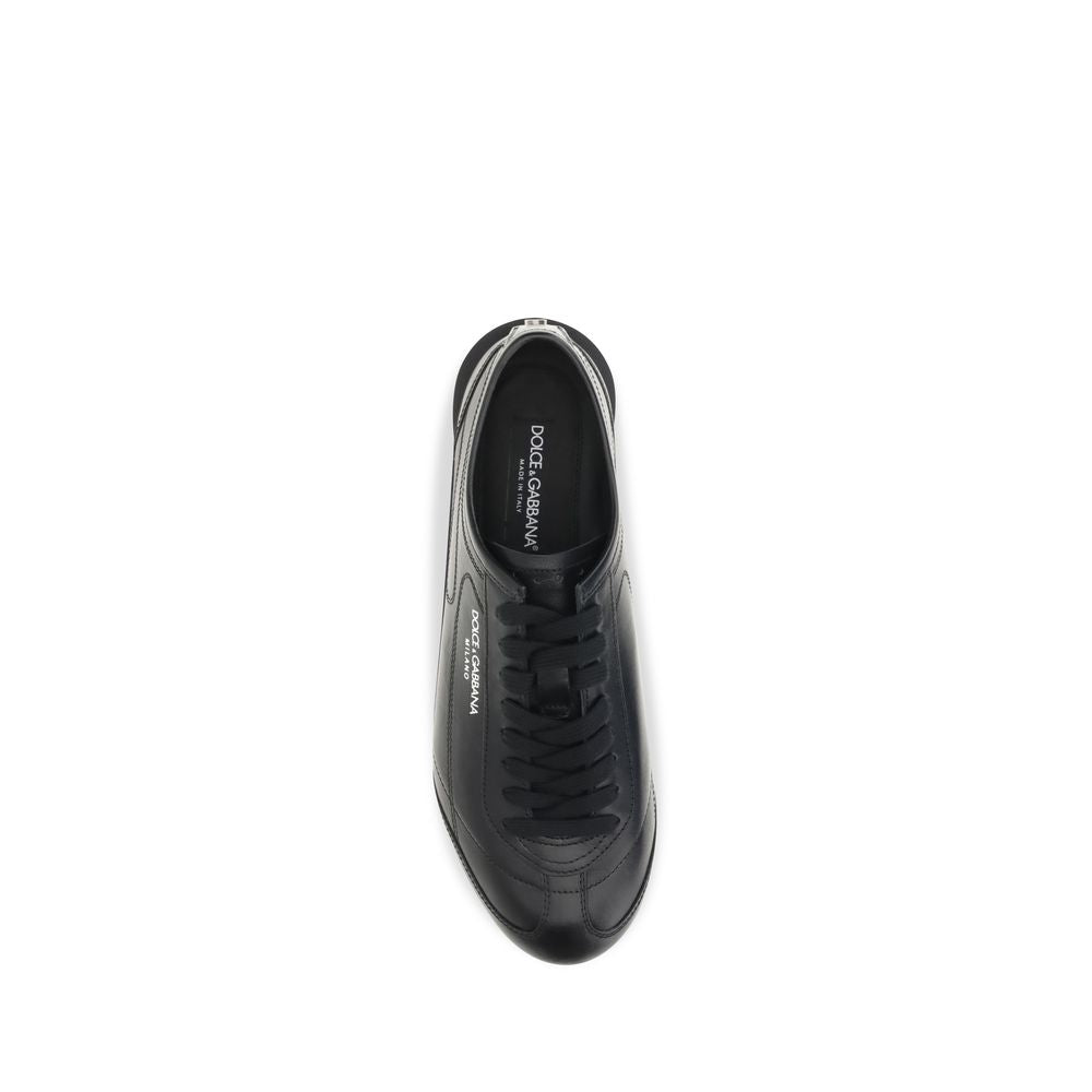 Indulge in the exquisite craftsmanship of Dolce & Gabbana's Black Calf Leather Bos Taurus Low Top Sneakers, where luxury meets refined elegance for the discerning individual.