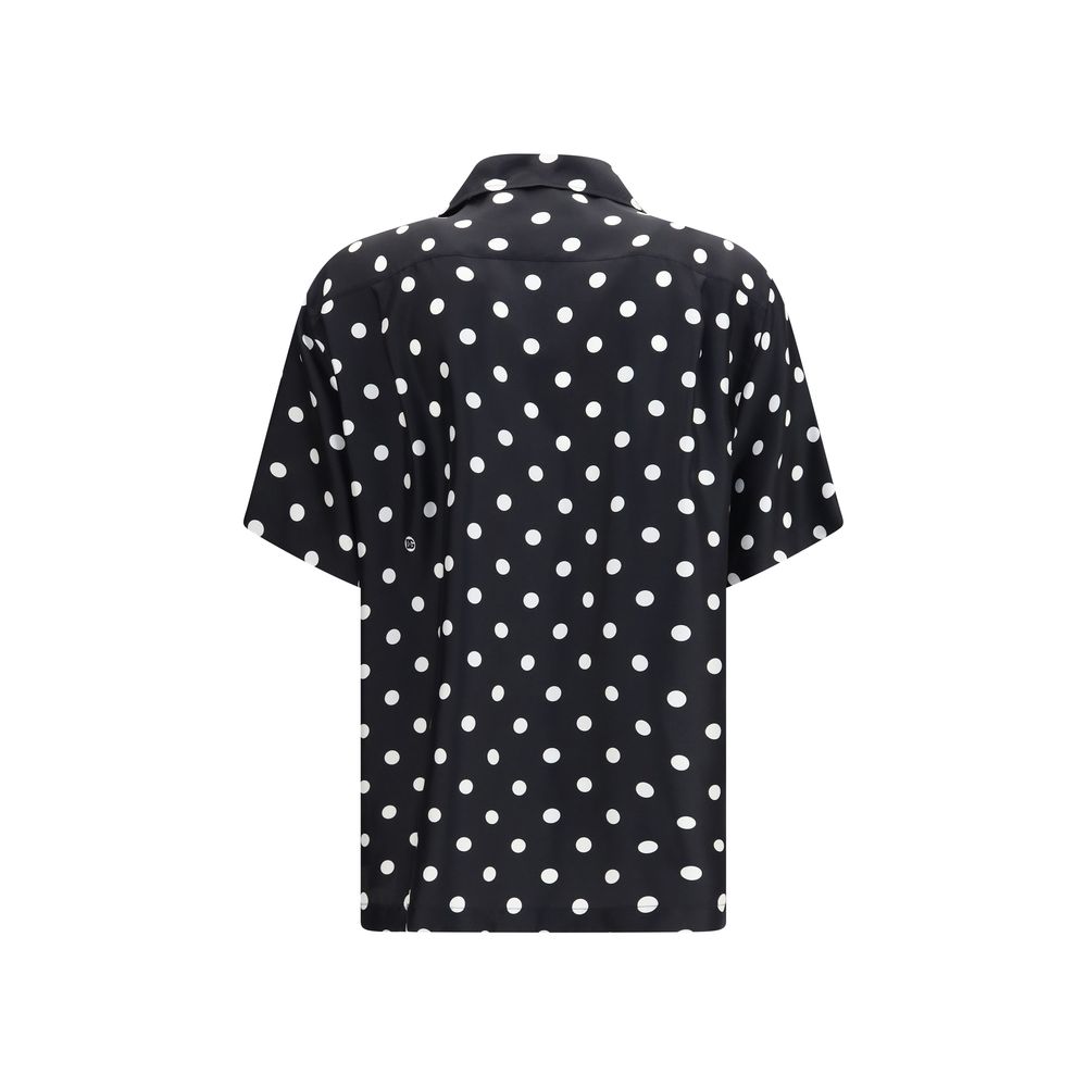Indulge in the artistry of Dolce & Gabbana's Black Silk Shortsleeve Shirt, where luxurious silk twill meets a vibrant polka dot print, redefining contemporary elegance.