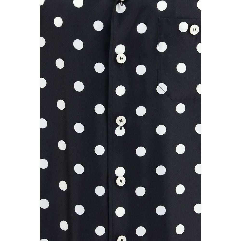 Indulge in the artistry of Dolce & Gabbana's Black Silk Shortsleeve Shirt, a unique blend of luxurious silk twill and vibrant polka dots, embodying contemporary elegance.