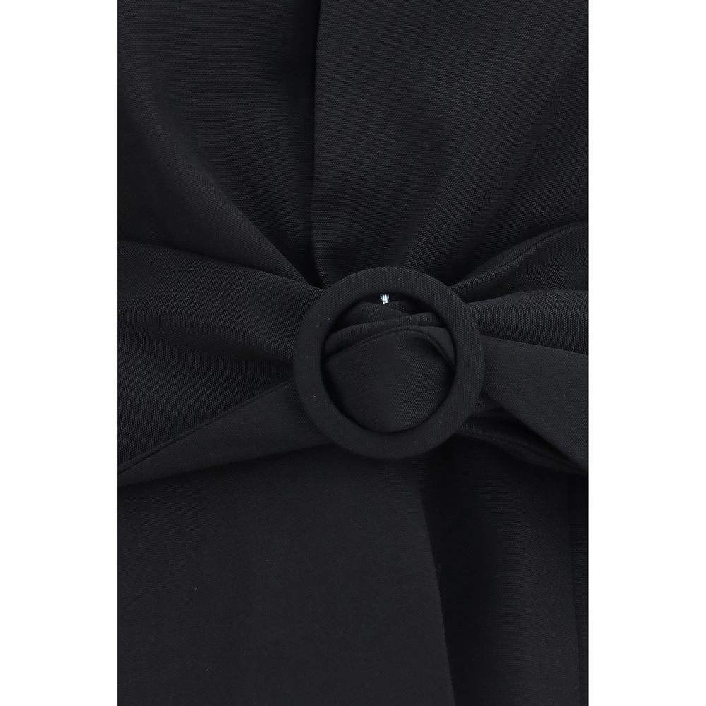 Indulge in the exquisite craftsmanship of the Jacquemus Black Wool Oves Aries Full-Length Jacket, a timeless piece that redefines elegance and sophistication for the discerning wardrobe.