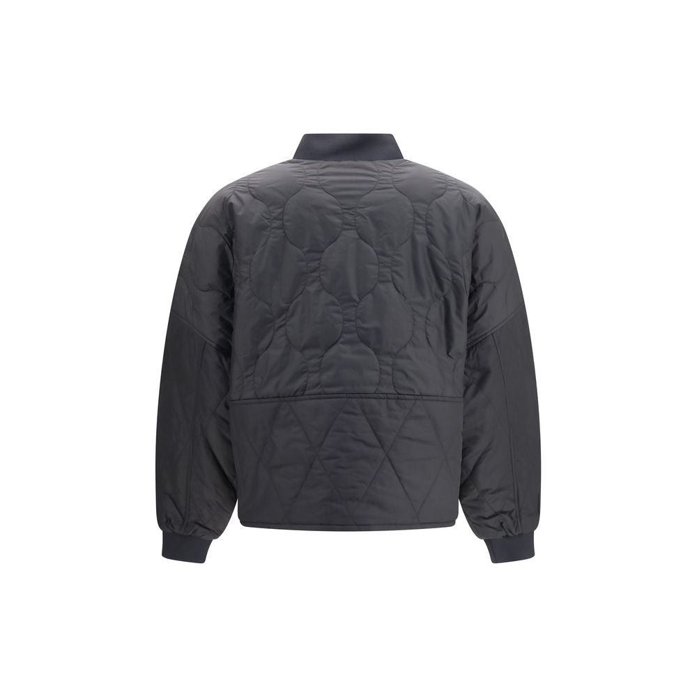 Indulge in the exquisite Barbour Black Polyester Bomber, a reversible quilted masterpiece that embodies sophistication and timeless elegance for the discerning individual.
