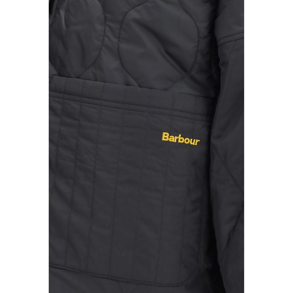 Indulge in the exquisite Barbour Black Polyester Bomber, a reversible quilted masterpiece that embodies timeless elegance and versatile luxury for the discerning individual.