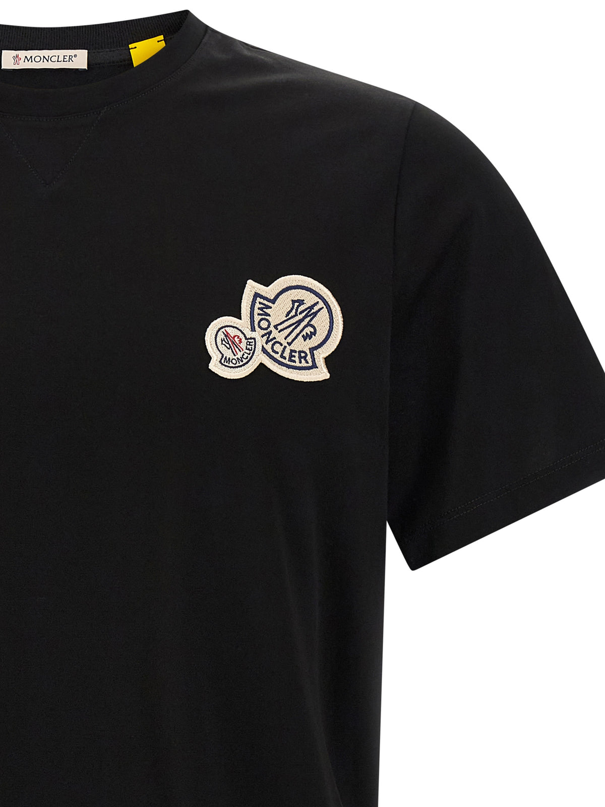 Elevate your wardrobe with the Moncler Black Cotton T-Shirt, a masterfully crafted essential that embodies timeless luxury and sophistication for the discerning individual.