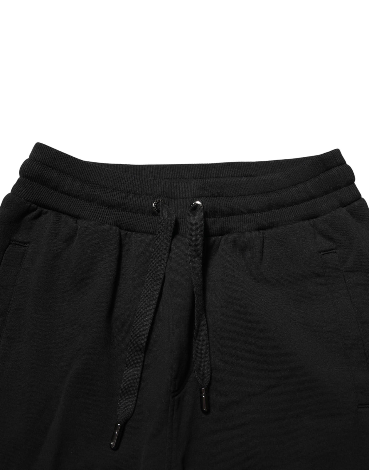 Indulge in the exquisite craftsmanship of Dolce & Gabbana's black cotton jogger pants, where luxury meets comfort, perfect for the discerning individual.