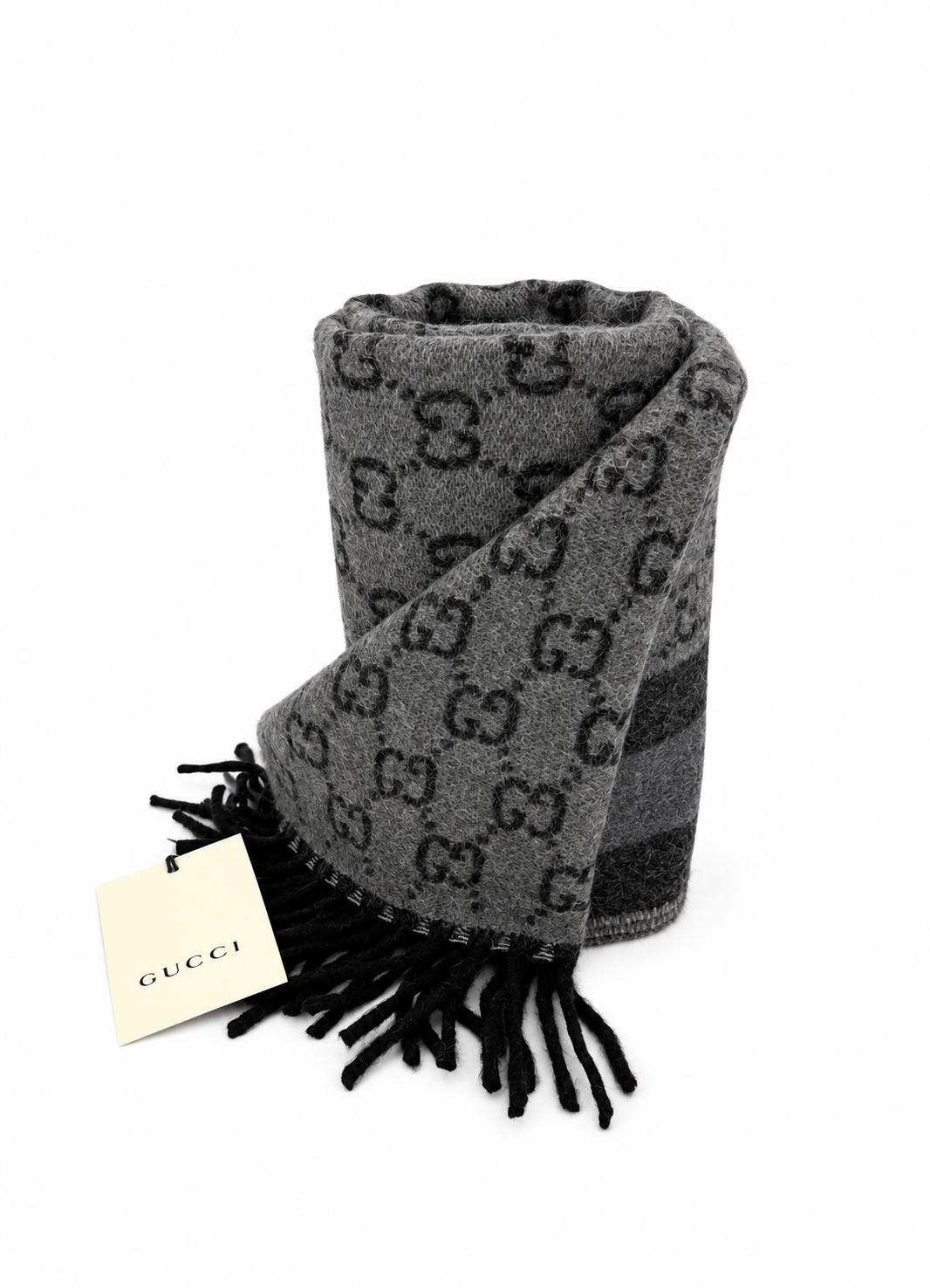 Indulge in the elegance of the Gucci Monogram Grey Wool Scarf, a luxurious blend of cashmere and wool, perfect for sophisticated autumn styling and timeless allure.