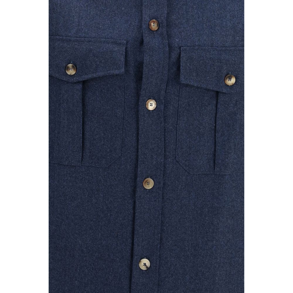 Elevate your wardrobe with the Brunello Cucinelli Blue Wool Oves Aries Shirt, a masterpiece of 100% Merino Wool, embodying timeless elegance and refined sophistication.
