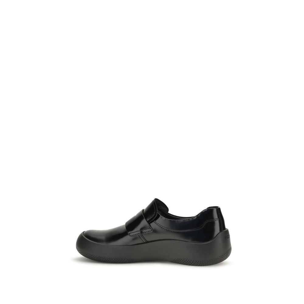Experience the allure of Prada's Black Calf Leather Bos Taurus Slip-On Loafers, where exquisite craftsmanship meets timeless elegance, perfect for the discerning individual.