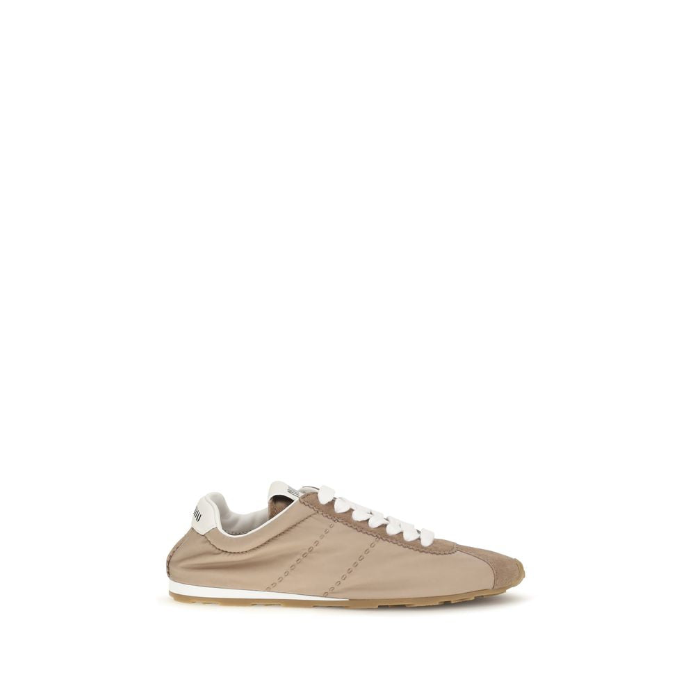 Elevate your style with Miu Miu's Beige Calf Leather Bos Taurus Low Top Sneakers, a masterpiece of refined craftsmanship, perfect for the modern connoisseur.