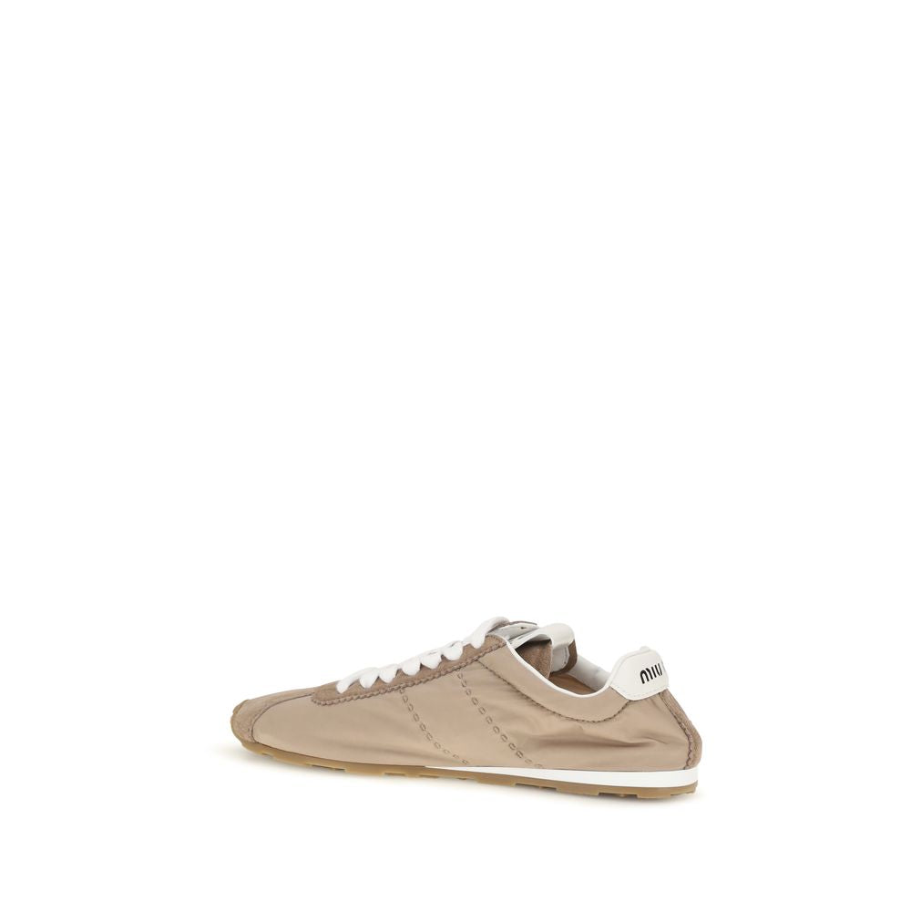 Elevate your style with Miu Miu's Beige Calf Leather Bos Taurus Low Top Sneakers, a perfect blend of sophistication and comfort for the modern connoisseur.