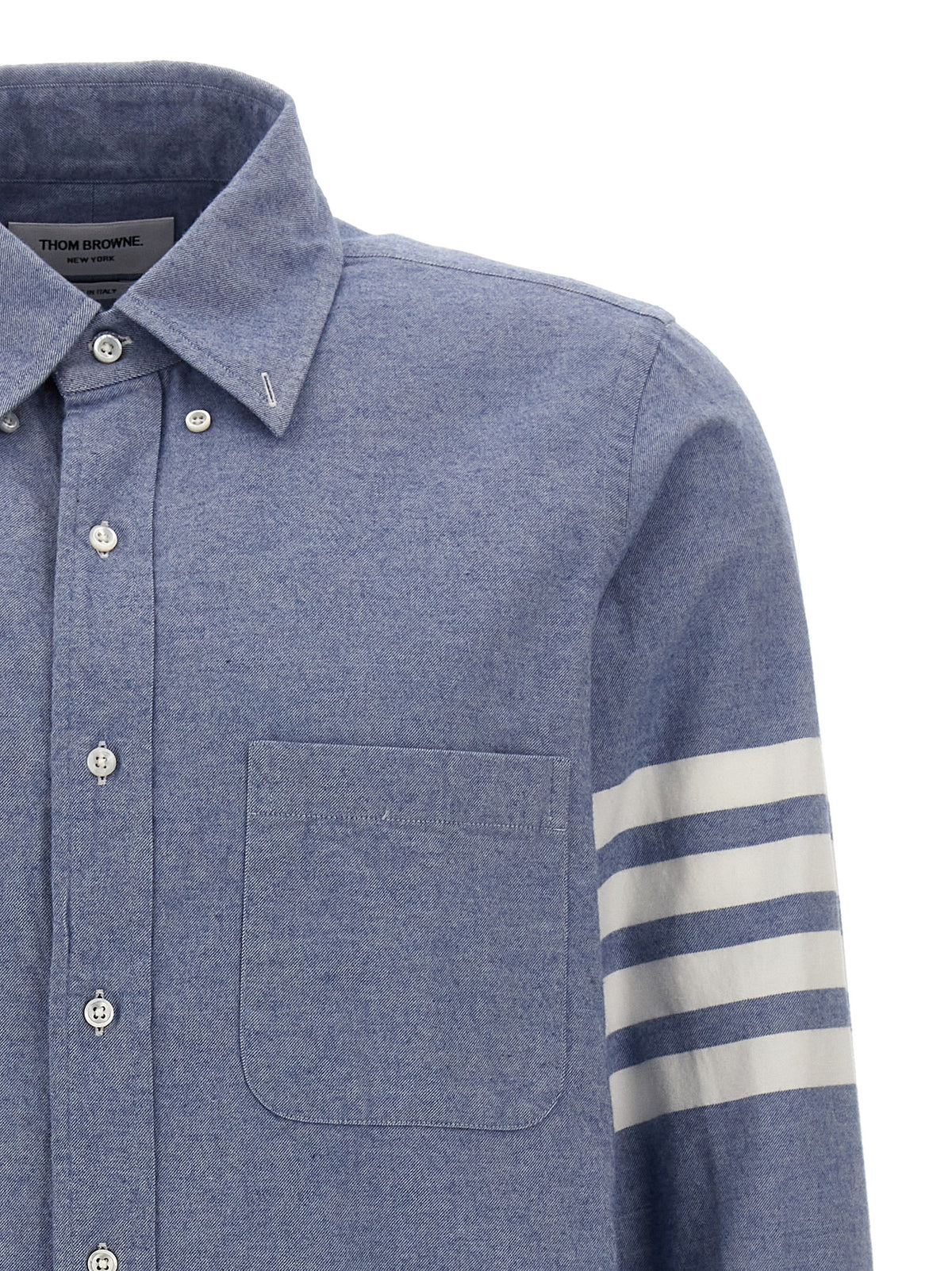 Elevate your wardrobe with the Thom Browne Blue Cotton Blouse, a refined piece crafted in Italy, embodying sophistication and effortless style for discerning tastes.