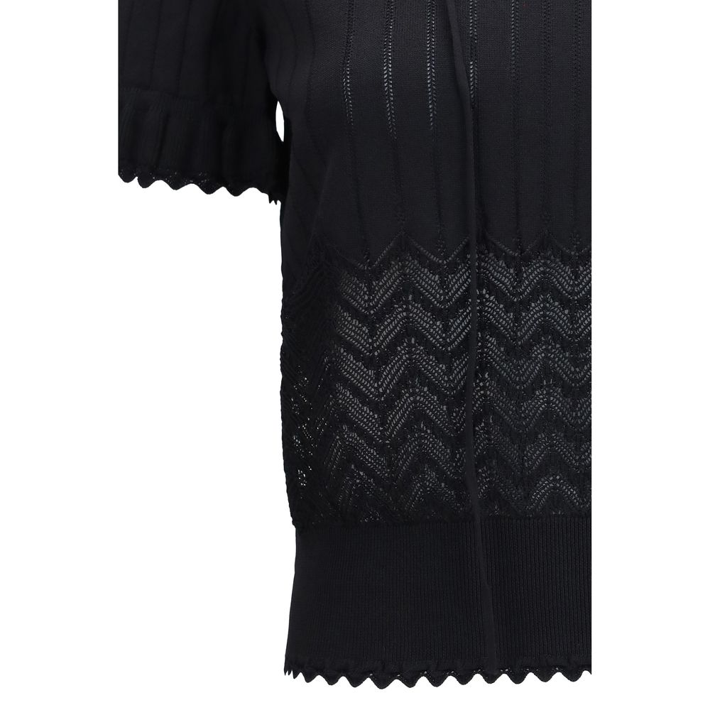Indulge in the exquisite allure of the Alexander McQueen Black Viscose T-Shirt, featuring a refined open-knit design and lace insert, perfect for the discerning individual.