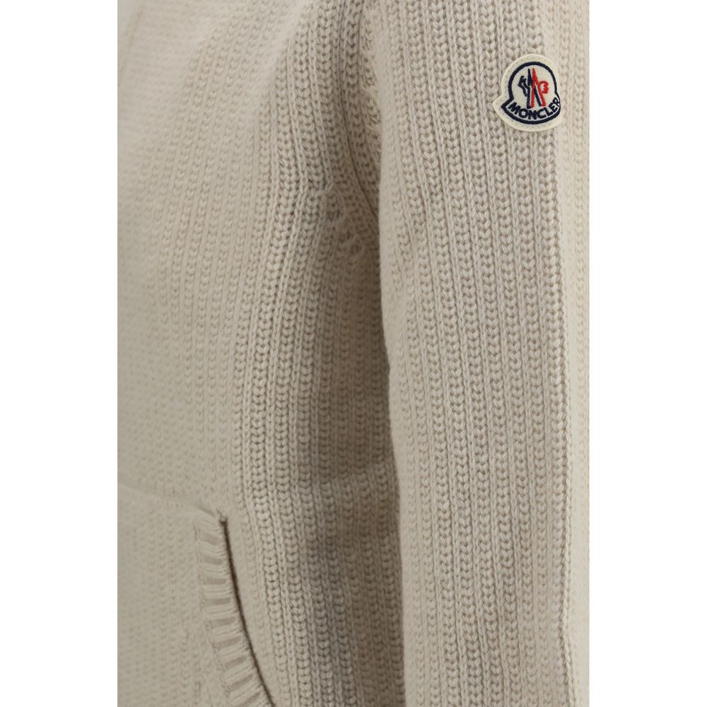 Indulge in the Moncler Beige Cashmere Sweater, a luxurious blend of wool and cashmere, featuring a refined high neck and elegant ribbed knit, perfect for discerning tastes.