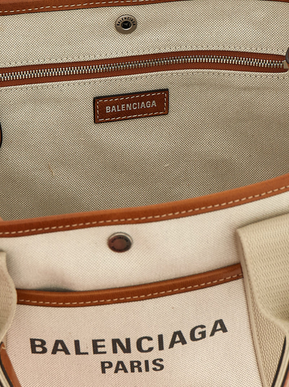 Discover the Balenciaga Beige Leather Tote Bag, a masterpiece of exquisite craftsmanship and timeless elegance, perfect for the discerning fashion connoisseur.