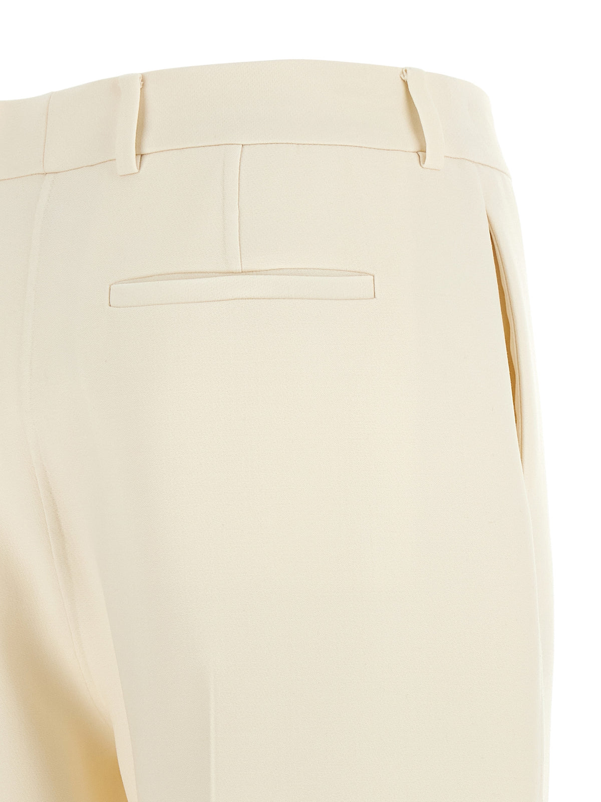 Elevate your wardrobe with Fendi's White Virgin Wool Dress Pants, a masterpiece of Italian craftsmanship that embodies sophistication and timeless elegance for the discerning trendsetter.