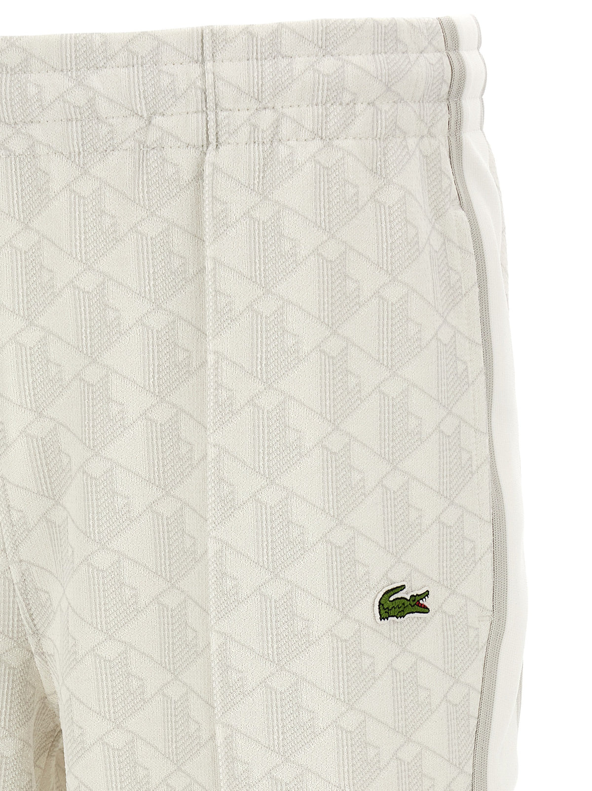 Elevate your wardrobe with Lacoste's White Polyester Joggers, a fusion of timeless elegance and modern style, crafted for those who command attention.