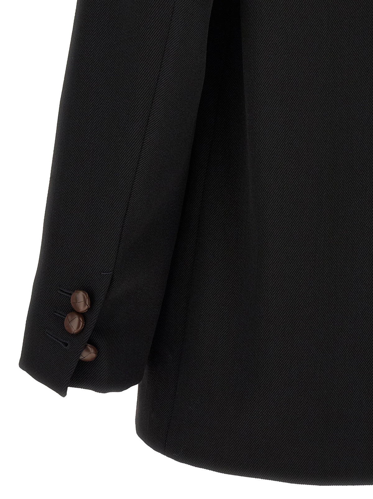 Elevate your wardrobe with ZEGNA's black wool blazer, a masterful blend of contemporary tailoring and tradition, embodying timeless elegance and sophistication.