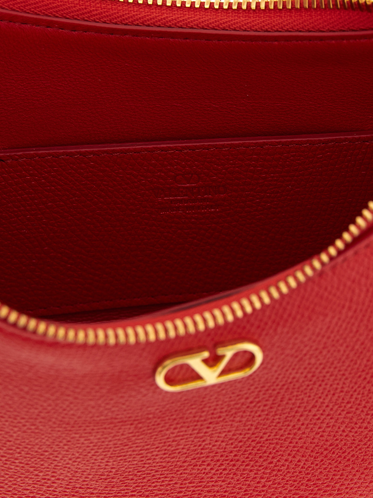 Indulge in the allure of the Valentino Garavani Red Calfskin Shoulder Bag, a masterpiece of Italian craftsmanship that elevates your style with its iconic design and luxurious materials.