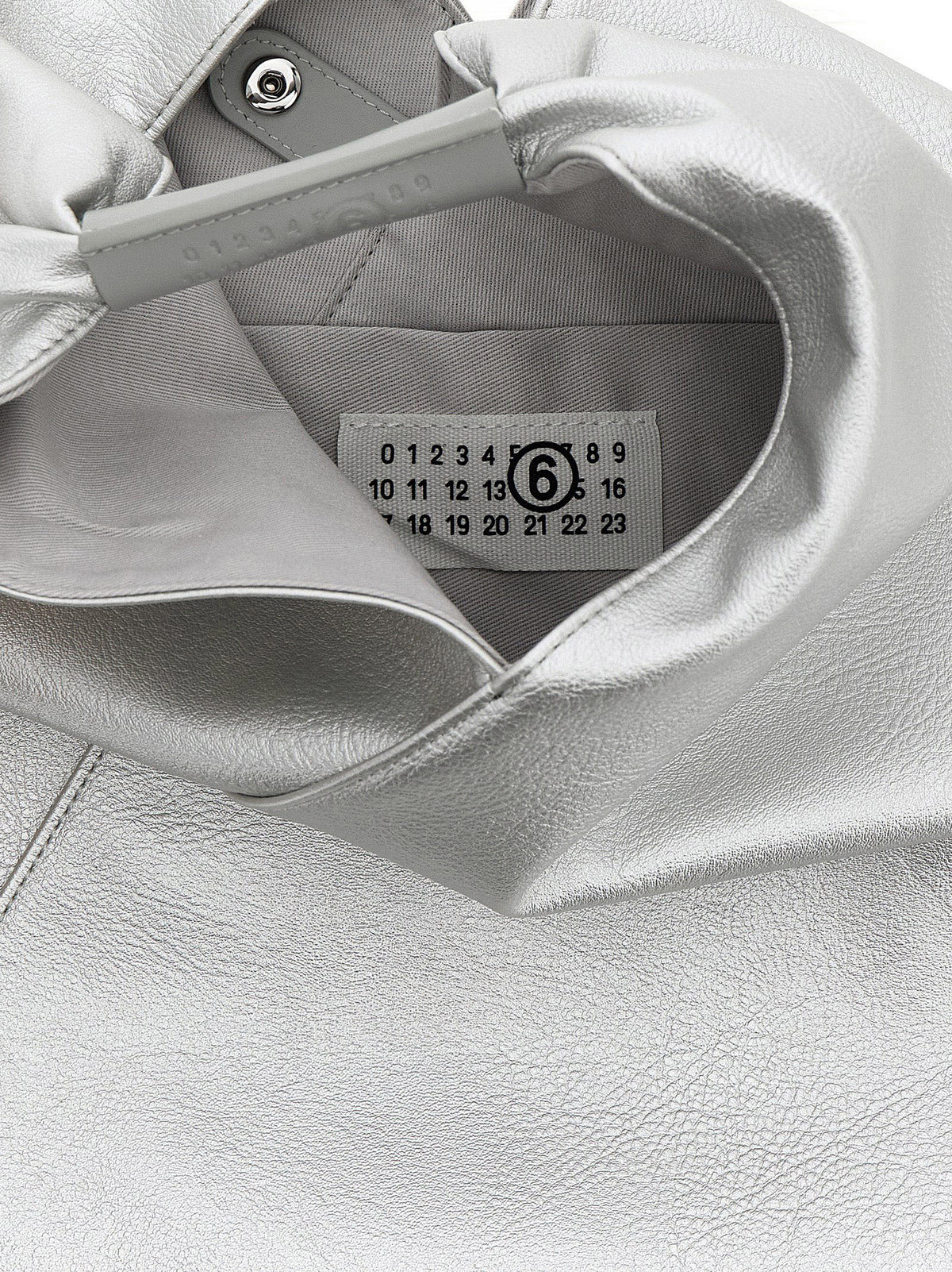 Discover the MM6 Maison Margiela Silver Polyethylene Handbag, a bold statement of luxury with its hammered leather-effect fabric and exquisite craftsmanship, perfect for the discerning individual.