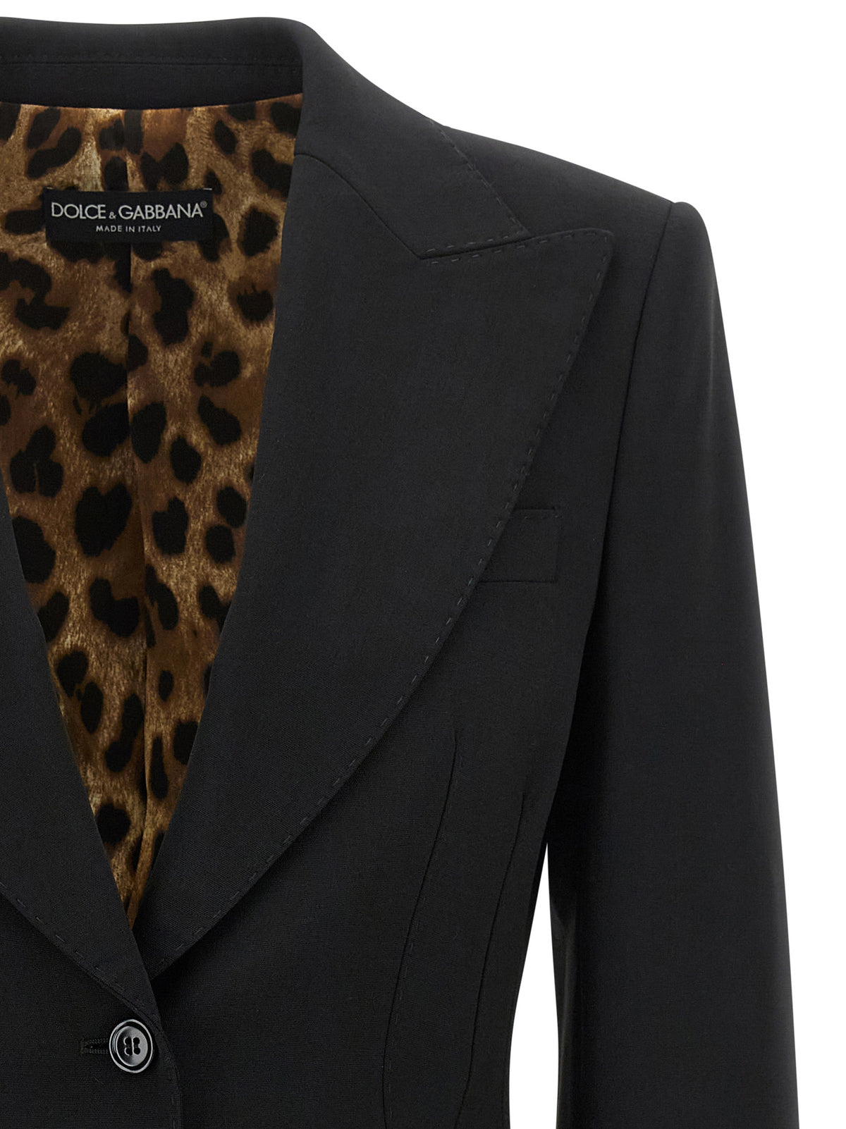 Elevate your wardrobe with the Dolce & Gabbana Black Virgin Wool Blazer, a masterpiece of Italian craftsmanship that embodies timeless elegance and sophisticated allure.