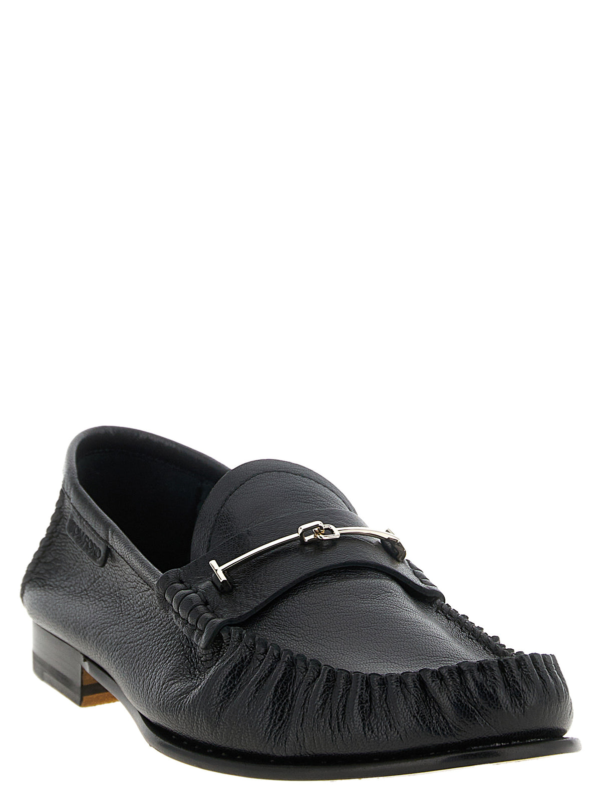 Indulge in the exquisite craftsmanship of Tom Ford's Black Goatskin Slip-On Loafers, where luxurious goat leather meets timeless elegance, perfect for the discerning individual.