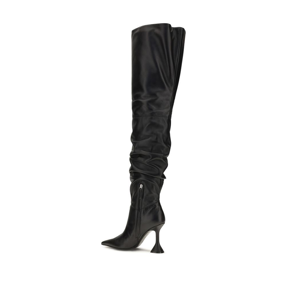 Indulge in the allure of Amina Muaddi's Black Calf Leather Over The Knee Boots, a masterpiece of craftsmanship that elevates your style with sophistication and elegance.